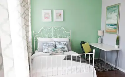 a bedroom with a white bed with a blue wall at Dream Catcher Travel House in Toronto