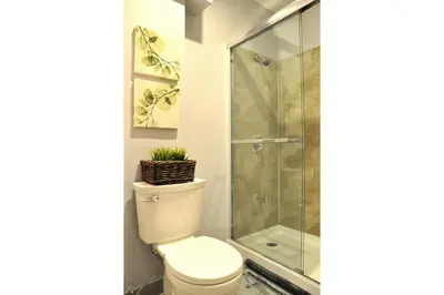 a bathroom with a toilet and a shower at Dream Catcher Travel House in Toronto