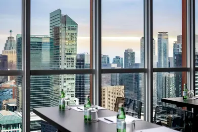 a view of a city skyline from a restaurant at BISHA, a Luxury Collection Hotel, Toronto in Toronto