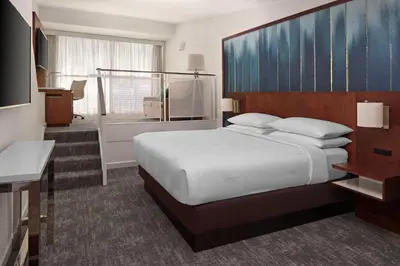 a hotel room with a large bed and a desk at Toronto Marriott City Centre Hotel in Toronto