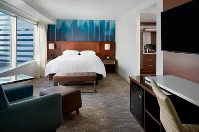 a hotel room with a bed and a tv at Toronto Marriott City Centre Hotel in Toronto