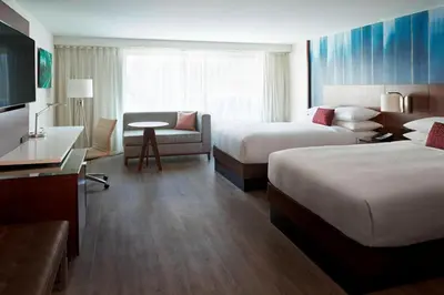 a hotel room with two beds and a couch at Toronto Marriott City Centre Hotel in Toronto
