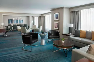 a living room with a couch and tables and chairs at Marriott Downtown at CF Toronto Eaton Centre in Toronto