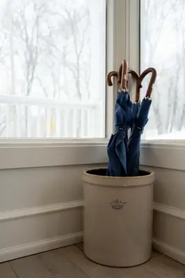 an umbrella in a bucket next to a window at South Landing Inn in Niagara on the Lake