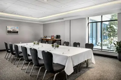a conference room with a large white table and chairs at Sheraton Toronto Airport Hotel & Conference Centre in Toronto