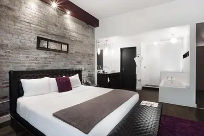 a bedroom with a large bed and a brick wall at Hotel Metro in London