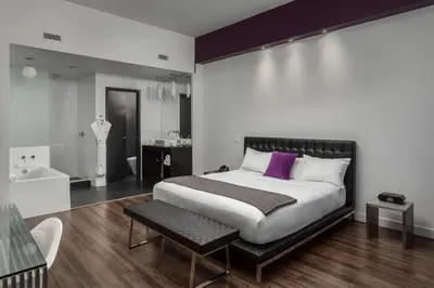 a bedroom with a large bed with a purple pillow at Hotel Metro in London