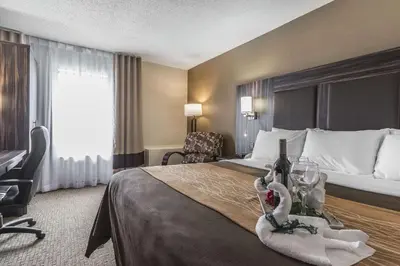 a hotel room with a bed with a bottle of wine at Comfort Inn Trenton in Trenton
