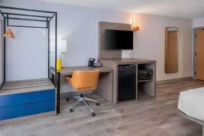 a hotel room with a desk and a chair at Comfort Inn in Belleville