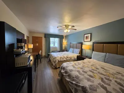 a hotel room with two beds and a ceiling fan at Shenstone Motor Inn in Wiarton
