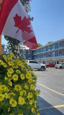 a canadian flag in front of a parking lot at Empress Inn and Suites by the Falls in Niagara Falls