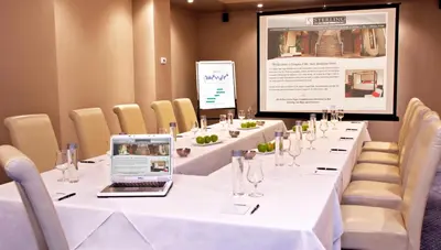 a conference room with a table with a laptop on it at Sterling Inn & Spa in Niagara Falls