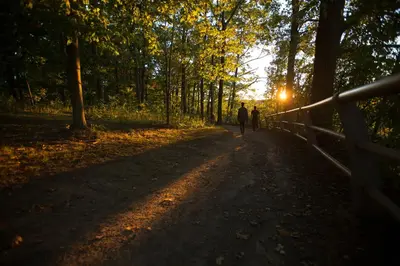 two people walking down a path in the woods at Sterling Inn & Spa in Niagara Falls