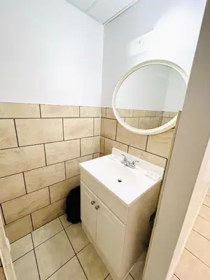 a bathroom with a sink and a mirror at Fairway Inn by the Falls in Niagara Falls