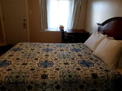 a bed in a hotel room with a quilt on it at Blue Moon Motel in Niagara Falls