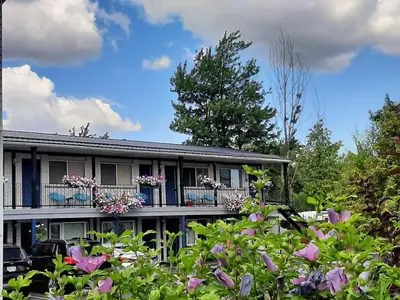 a house with flowers in front of it at Blue Moon Motel in Niagara Falls