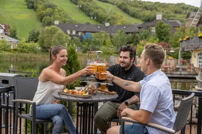 a group of people sitting around a table with drinks at The Westin Trillium House, Blue Mountain in Blue Mountains