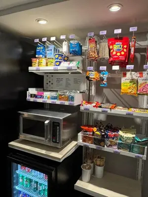 a kitchen with a microwave and some food at Spark by Hilton Oshawa in Oshawa