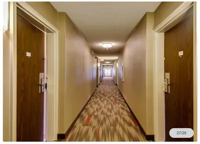 a long hallway with a long aisle with doors at Spark by Hilton Oshawa in Oshawa