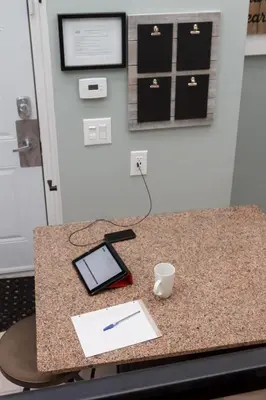 a desk with a tablet and a pen on it at Mountain Side Condo Loft at The Blue Mountains in Blue Mountains