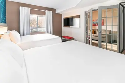 a hotel room with two beds and a tv at Comfort Suites in London