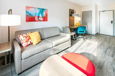 a living room with a couch and a table at Comfort Suites in London