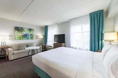 a hotel room with a bed and a couch at Staybridge Suites Guelph by IHG in Guelph