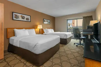 a hotel room with two beds and a television at Comfort Inn in Orillia