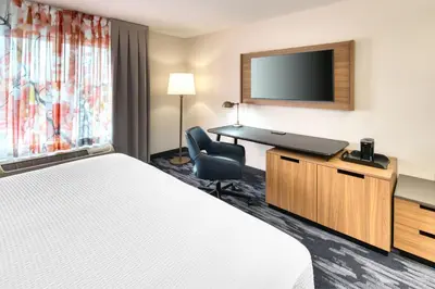 a hotel room with a bed and a desk and a television at Fairfield Inn & Suites by Marriott Toronto Brampton in Brampton