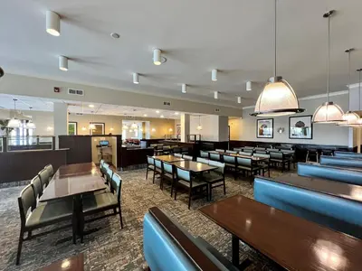 a dining room with tables and chairs and tablesktop at Holiday Inn Toronto Airport East by IHG in Toronto