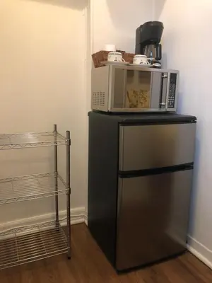 a microwave oven sitting on top of a refrigerator at The Rex Motel At Niagara Falls in Niagara Falls