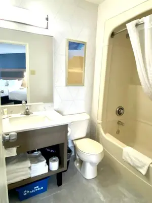 a bathroom with a sink and a toilet and a tub at Comfort Inn in St. Catharines
