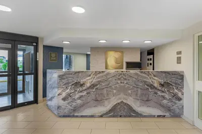 a lobby with a large marble wall in the middle at Comfort Inn in St. Catharines