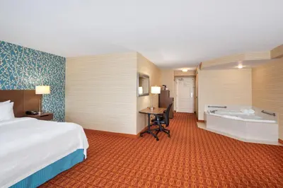 a hotel room with a bed and a bath tub at Fairfield Inn & Suites by Marriott Toronto Airport in Mississauga