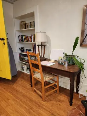 a wooden desk with a chair in a room at Stone Carriage House in Picton