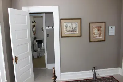 a door leading into a room with two pictures on the wall at Green Oaks B&B in Niagara on the Lake
