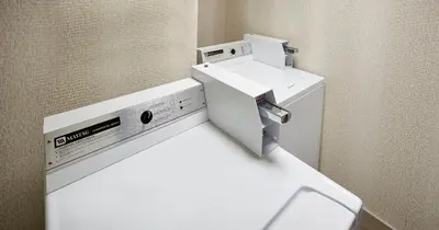 a bathroom with a toilet and a sink at Holiday Inn & Suites Oakville at Bronte by IHG in Oakville