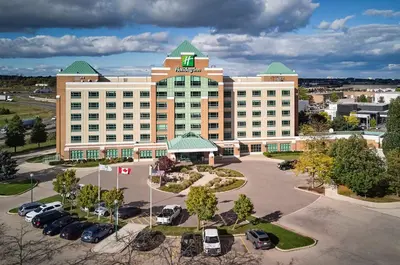 an aerial view of a hotel with a parking lot at Holiday Inn & Suites Oakville at Bronte by IHG in Oakville