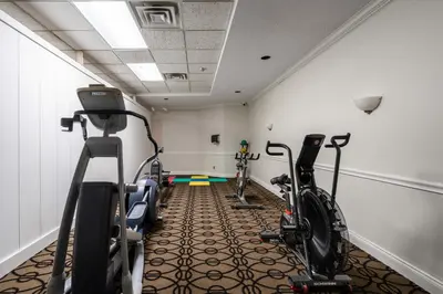 a gym with two bikes in a room at Ramada Plaza by Wyndham Niagara Falls in Niagara Falls