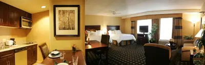 a hotel room with a bed and a kitchen at Homewood Suites by Hilton Toronto Airport Corporate Centre in Toronto
