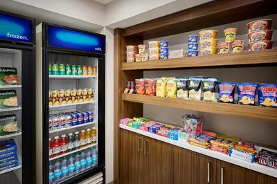 a grocery store aisle with a refrigerator and food at Holiday Inn Express & Suites Kitchener Southeast by IHG in Kitchener