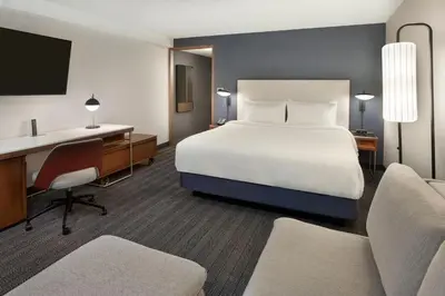 a hotel room with a bed and a desk at Courtyard by Marriott Toronto Mississauga/Meadowvale in Mississauga