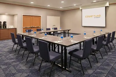 a conference room with a long table and chairs at Courtyard by Marriott Toronto Mississauga/Meadowvale in Mississauga