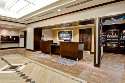 a large lobby with a bar in the middle at Hampton Inn by Hilton Toronto Airport Corporate Centre in Toronto