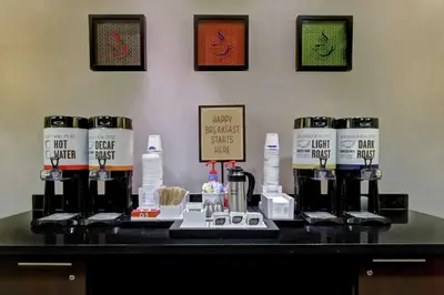a table with a bunch of bottles of coffee on it at Hampton Inn by Hilton Toronto Airport Corporate Centre in Toronto