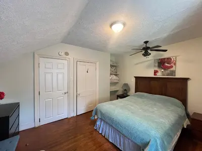 a bedroom with a bed and a ceiling fan at WHITE SWAN House in Niagara Falls