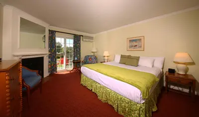 a bedroom with a large bed and a fireplace at Briars Resort and Spa in Georgina