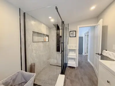 a bathroom with a walk in shower next to a sink at Addison House License# 004-2025 in Niagara on the Lake