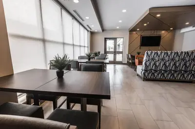 a dining room with tables and chairs and a tv at Holiday Inn Express Toronto-North York by IHG in Toronto