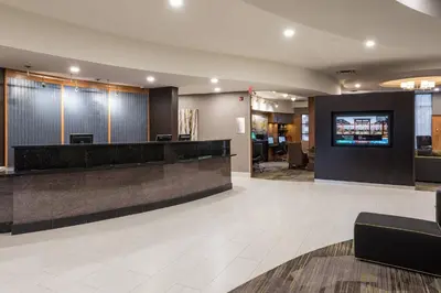 a lobby of a hotel with a reception desk at Courtyard by Marriott Toronto Vaughan in Vaughan